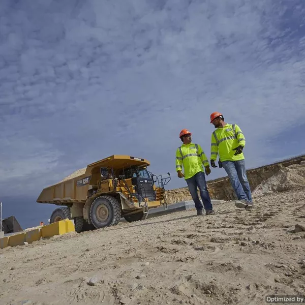 two men in front of a truck